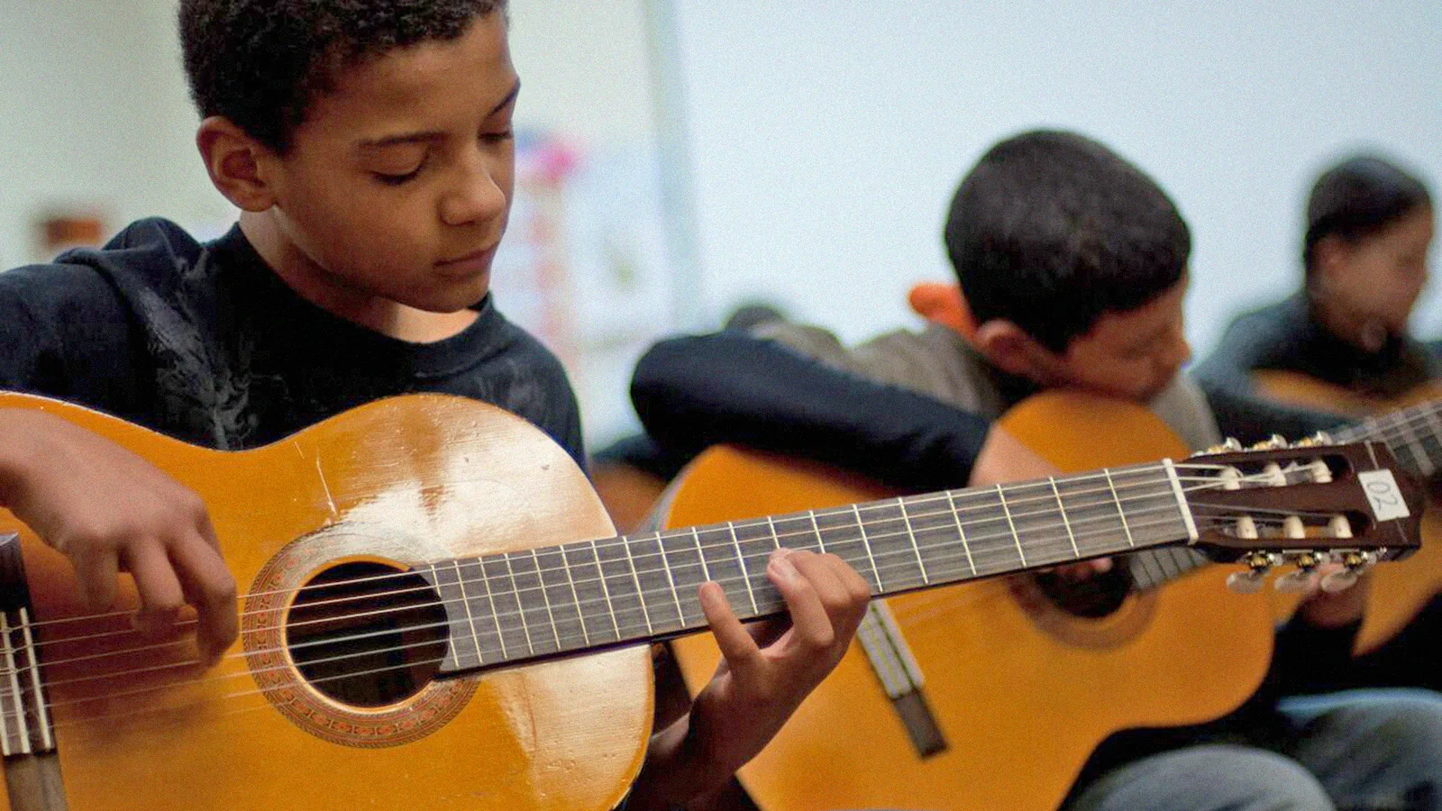 2020_05_08-header_nm-arts Child Playing Guitar