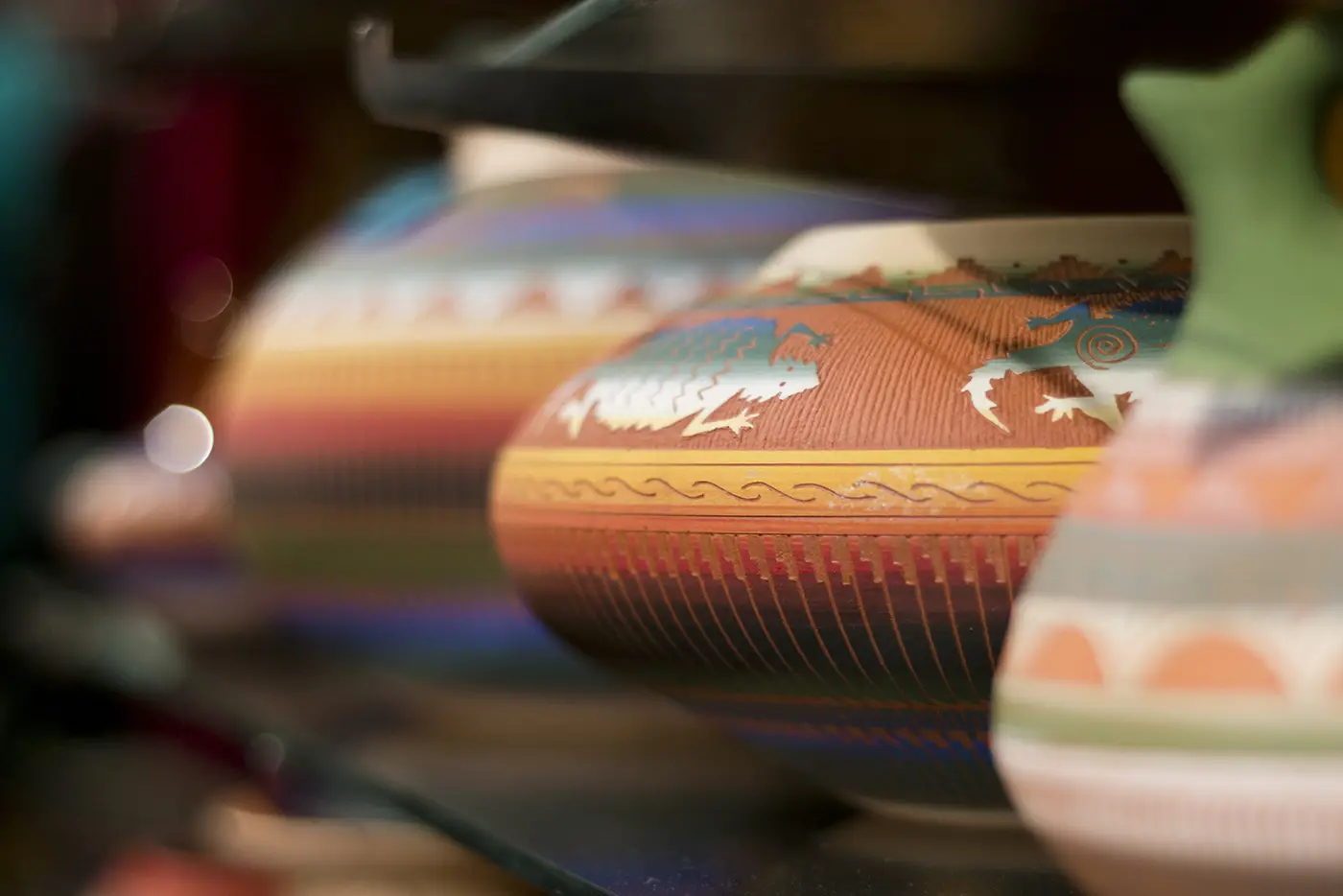 Row of pottery with vivid colors and textures.