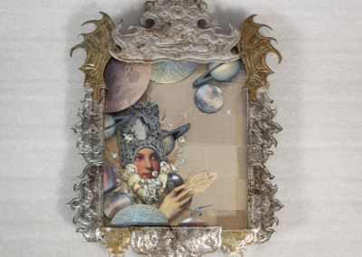 Assemblage in an ornate silver and gold tin frame with scrolled and pointed flourishes, holding a collage of a woman in a jeweled headdress surrounded by planets and moons.